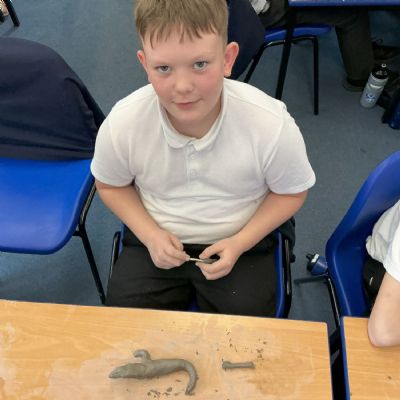 Children making clay lizards